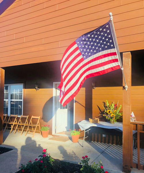 american flag hanging outside a house